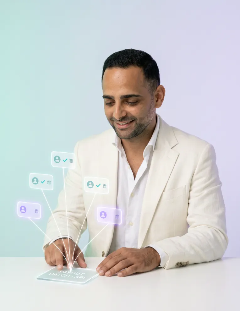 A smiling man in a cream jacket taps a glass tablet as account notifications float above it